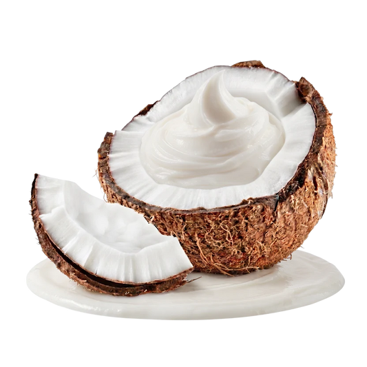 A halved coconut with creamy white coconut cream inside, shown with a smaller cut piece in front on a white surface