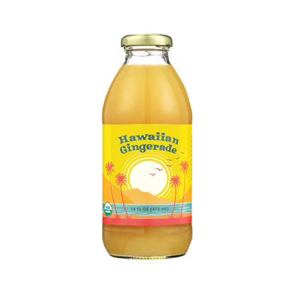 A 16 fl oz glass bottle of Big Island Organics Hawaiian Gingerade juice with a yellow label featuring a sunset and palm tree design, topped with a gold cap