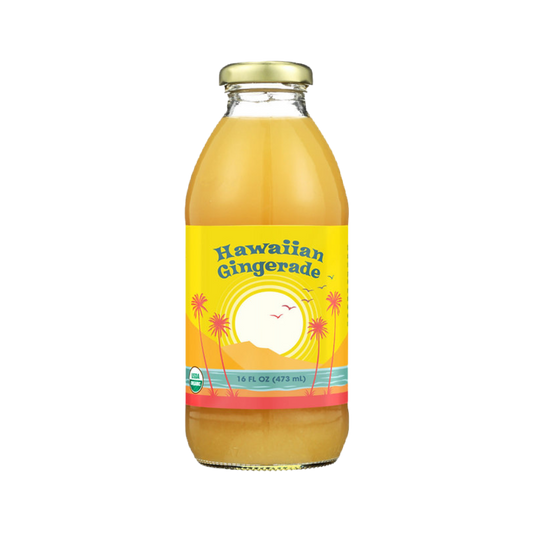 A 16 fl oz glass bottle of Big Island Organics Hawaiian Gingerade juice with a yellow label featuring a sunset and palm tree design, topped with a gold cap