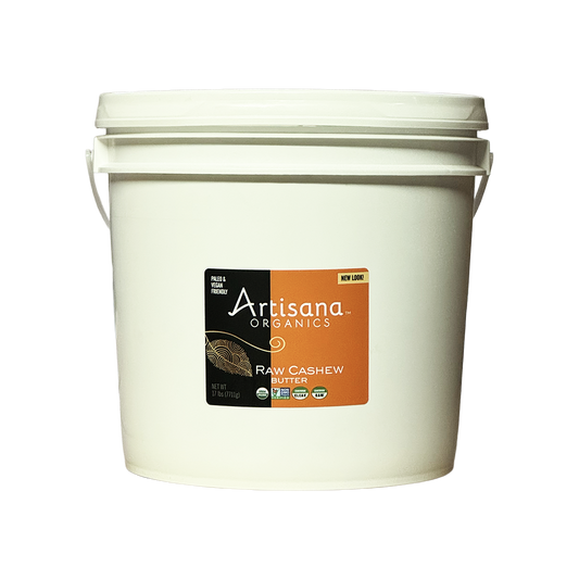 A white plastic bucket of Artisana Organics Raw Cashew with a black and orange label