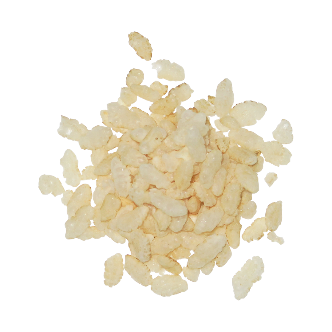 A pile of small, irregular pale beige crispy brown rice cereal