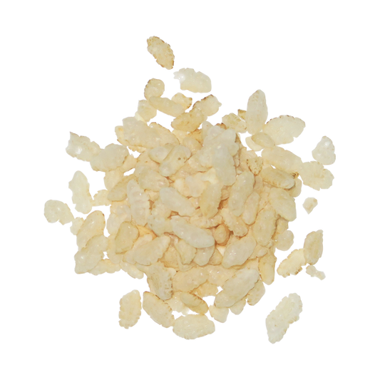 A pile of small, irregular pale beige crispy brown rice cereal